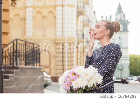 Cheerful young woman is sightseeing in town Cheerful young woman is sightseeing in town 16764283