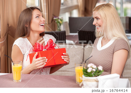Pretty young woman are celebrating in cafe 16764414