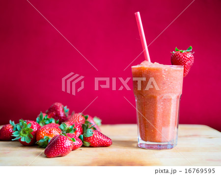 Strawberry smoothie in glass with straw Strawberry smoothie in glass with straw 16769595