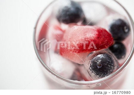 close up of fruit water with ice cubes in glass close up of fruit water with ice cubes in glass 16770980