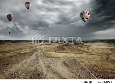 Air balloons over the country road 16776094