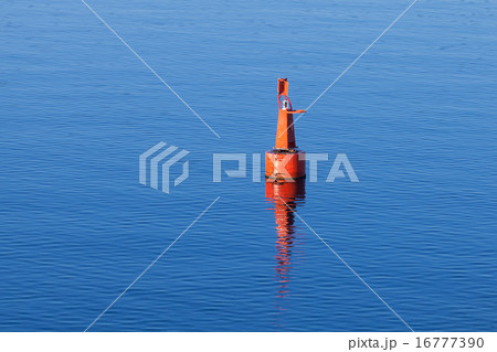 Red modern navigation buoy on still water 16777390