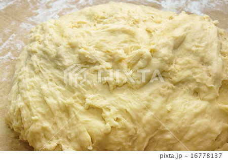 Closeup piece of kneaded yeasty raw dough Closeup piece of kneaded yeasty raw dough 16778137