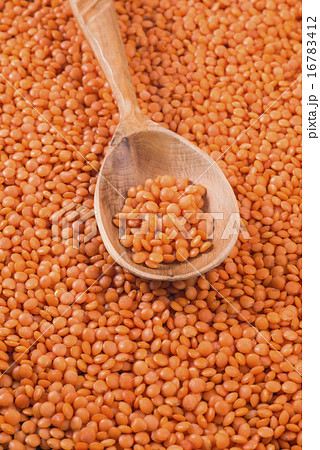 Orange lentils in wooden spoon 16783412