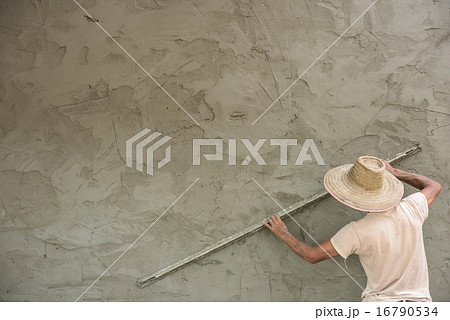 Builder worker plastering concrete at wall Builder worker plastering concrete at wall 16790534