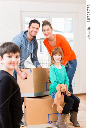 Family with moving boxes in new home Family with moving boxes in new home 16793776