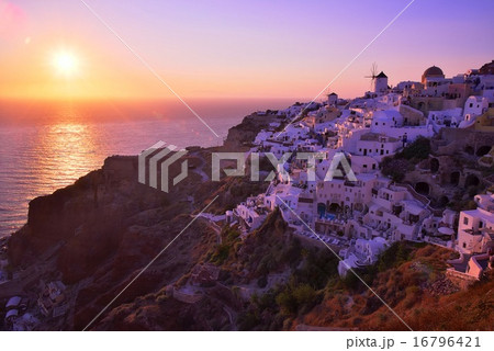 サントリーニ島イアの町並みとエーゲ海に沈む夕日 16796421