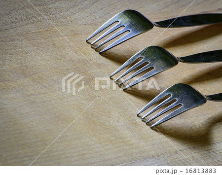 Three forks on a wooden board Three forks on a wooden board 16813883