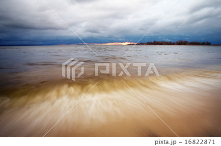 Landscape with cloudy sky and a lake with waves. Landscape with cloudy sky and a lake with waves. 16822871