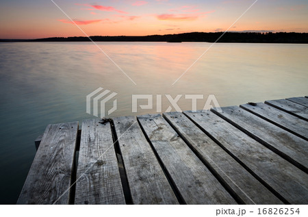 Small wooden pier on big lake at sunset 16826254