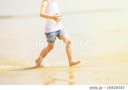 Child running beach shore splashing water Child running beach shore splashing water 16828587