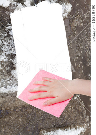 hand deletes melting snow by pink rag 16829790