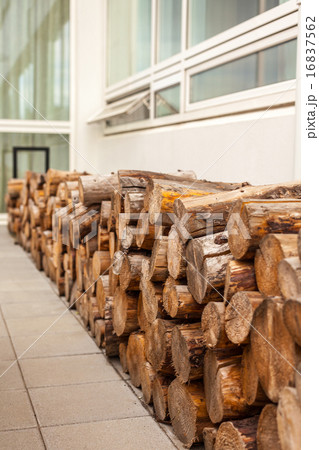 Logs woodpile near modern building house wall 16837562