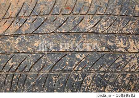 Old crack car tire with brown dirt 16839882