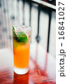 Orange cocktail with mint leaves outdoors 16841027