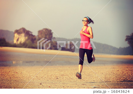 young woman running at sunrise beach young woman running at sunrise beach 16843624