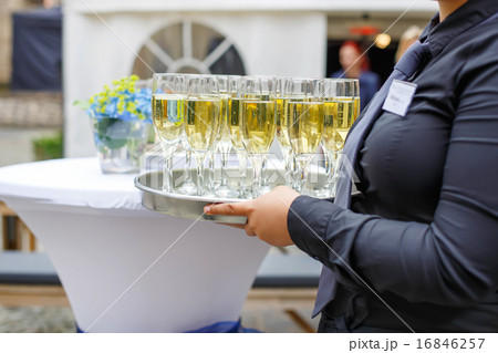 Waitress with dish of champagne and wine glasses 16846257