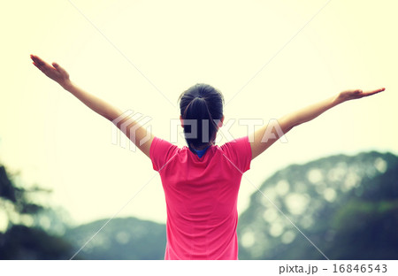 cheering young asian woman open arms on bridge cheering young asian woman open arms on bridge 16846543