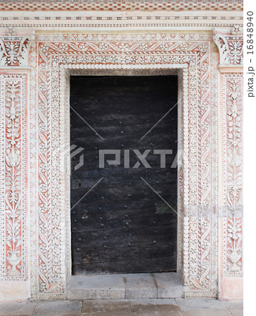 Ancient door with decorative portal 16848940