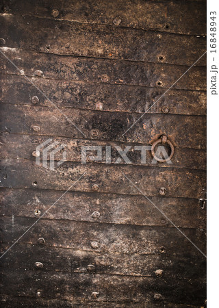 Vintage door protected with dark iron plates 16848943