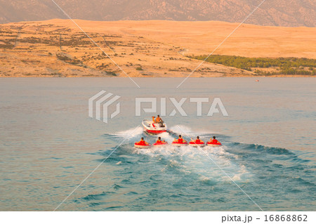 Kids tube riding tawed by speedboat. Kids tube riding tawed by speedboat. 16868862