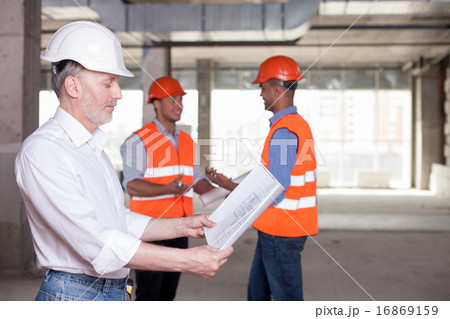 Cheerful construction team is discussing a new project 16869159