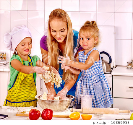 Mother and grandchild baking cookies. Mother and grandchild baking cookies. 16869953
