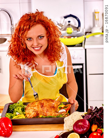 Woman cooking chicken at kitchen. 16870091