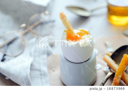 The soft-boiled egg in an eggcup with toasted brea 16873966