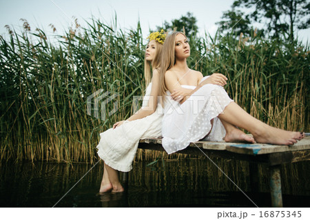 Two beautiful girls on coast at pier 16875345