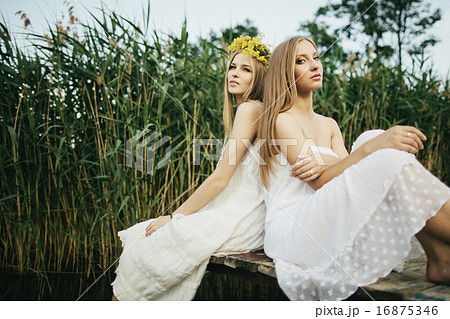 Two beautiful girls on coast at pier 16875346