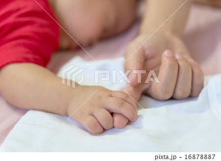 Baby hand gently holding mom finger 16878887