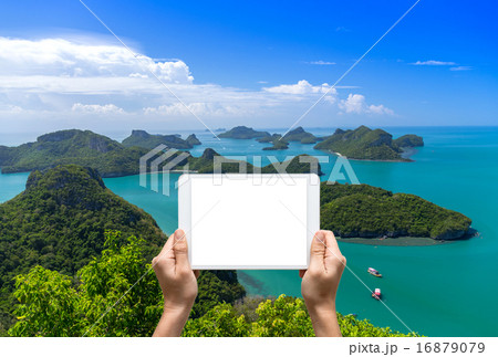 Female hands holding tablet taking pictures Top view of Ang Thon 16879079