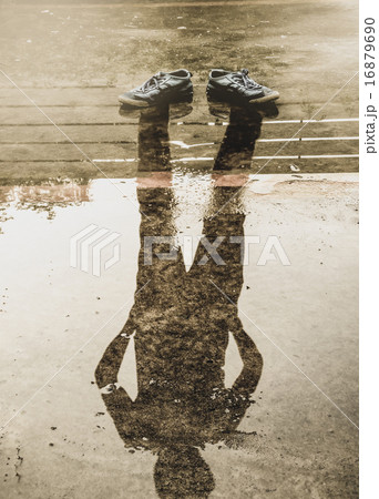 The man reflection in the water after raining 16879690