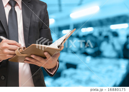 Businessman writing the note book on Abstract blurred photo of b 16880175