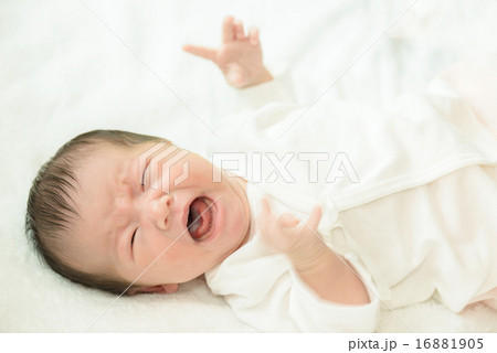 白い産着にくるまれて泣いている新生児 16881905