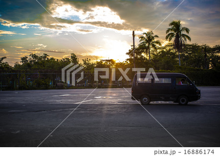 Side View On Asphalt Street at sunrise in Malaysia and drives car Side View On Asphalt Street at sunrise in Malaysia and drives car 16886174