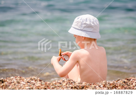 Little boy play near sea Little boy play near sea 16887829