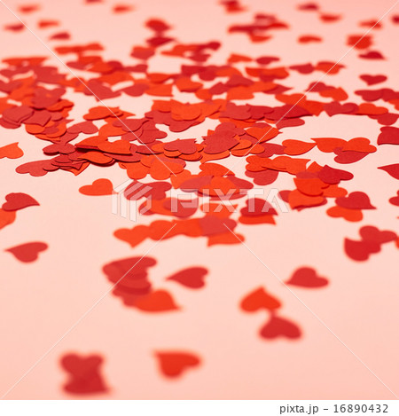 Heart shapes over pink surface 16890432