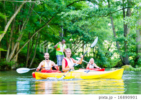 Friends paddling with canoe on forest river Friends paddling with canoe on forest river 16890901