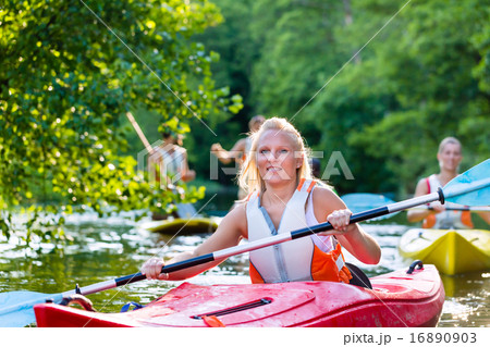 Friends driving with kayak on forest river 16890903