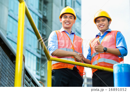 Asian construction workers on building site 16891052