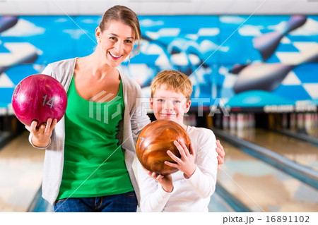 Mother and son playing together at bowling center Mother and son playing together at bowling center 16891102