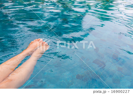 Female legs in the swimming pool water Female legs in the swimming pool water 16900227