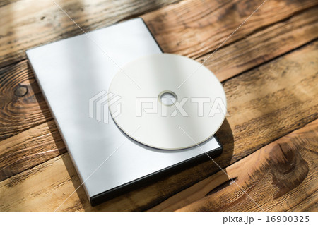 Blank compact disc with cover on wood background ground Blank compact disc with cover on wood background ground 16900325