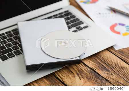 Blank compact disc with cover on laptop keyboard Blank compact disc with cover on laptop keyboard 16900404