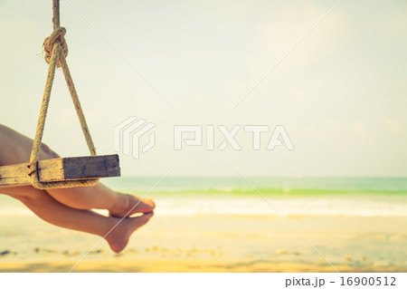 Woman leg on a swing at tropical sea beach 16900512