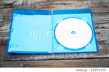 Blank compact disc with cover on wood background ground 16901030