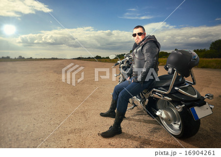Biker sitting on a motorcycle Biker sitting on a motorcycle 16904261