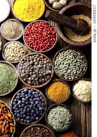 Assortment of spices in wooden bowl background Assortment of spices in wooden bowl background 16908937